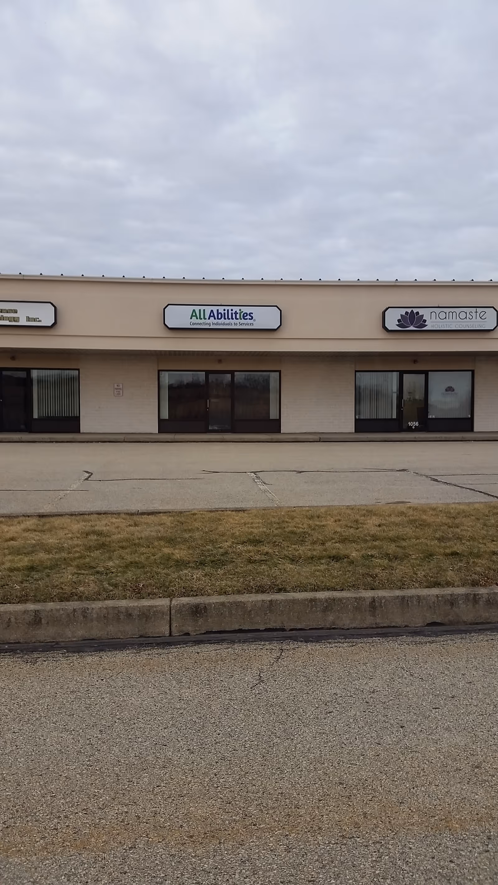 Exterior view of a storefront with All Abilities Inc and Namaste signage