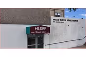 Exterior view of Faith Haven Apartments with a Hi-Rise Beauty Salon sign