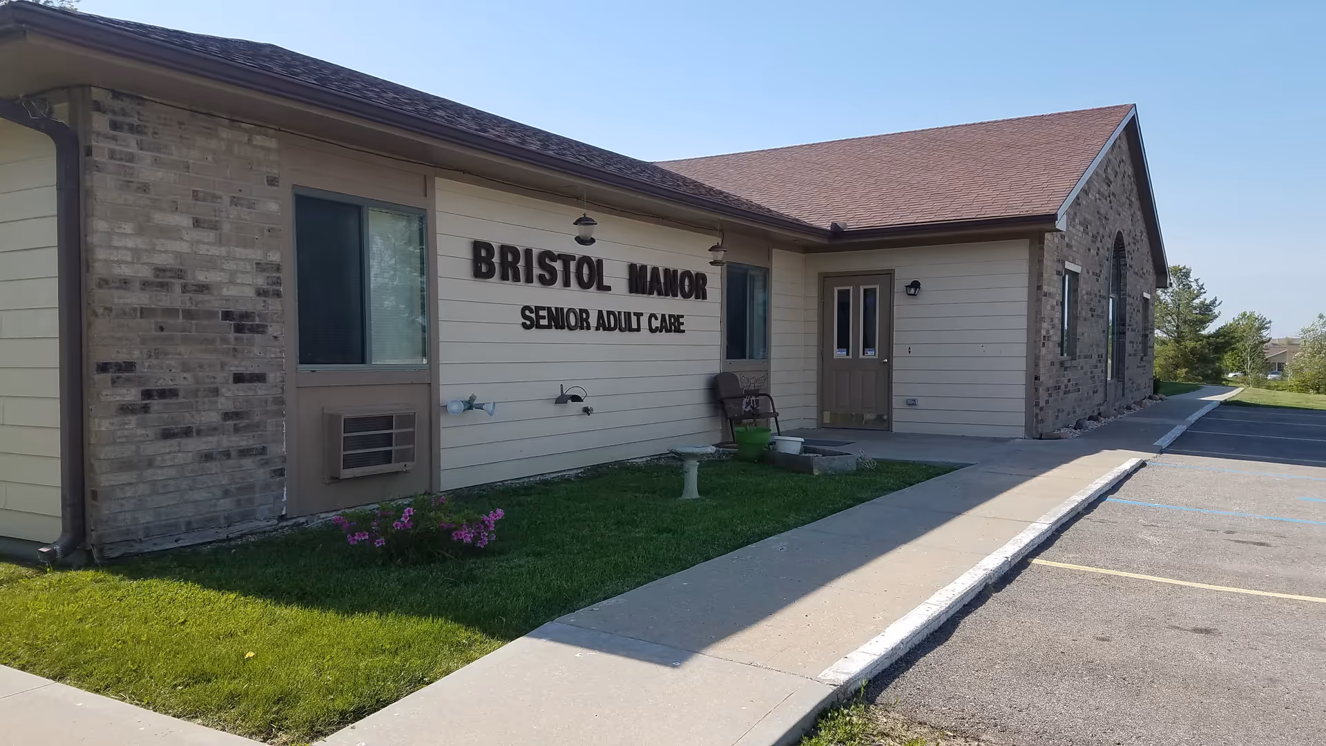 Front exterior of Bristol Manor Maryville Senior Care building with sign and entrance.