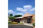 Front exterior of Ross Center for Nursing and Rehabilitation with entrance and landscaping