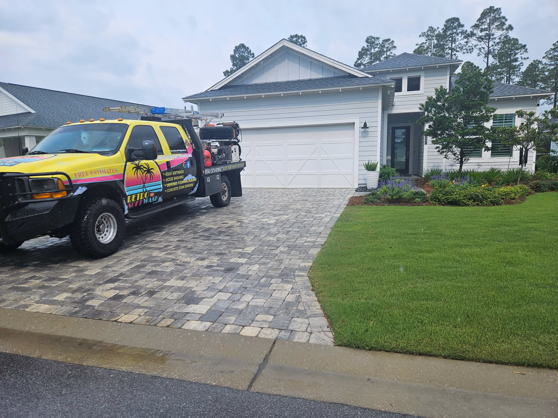 Colorful service van parked on a stone driveway in front of a modern residential facility.