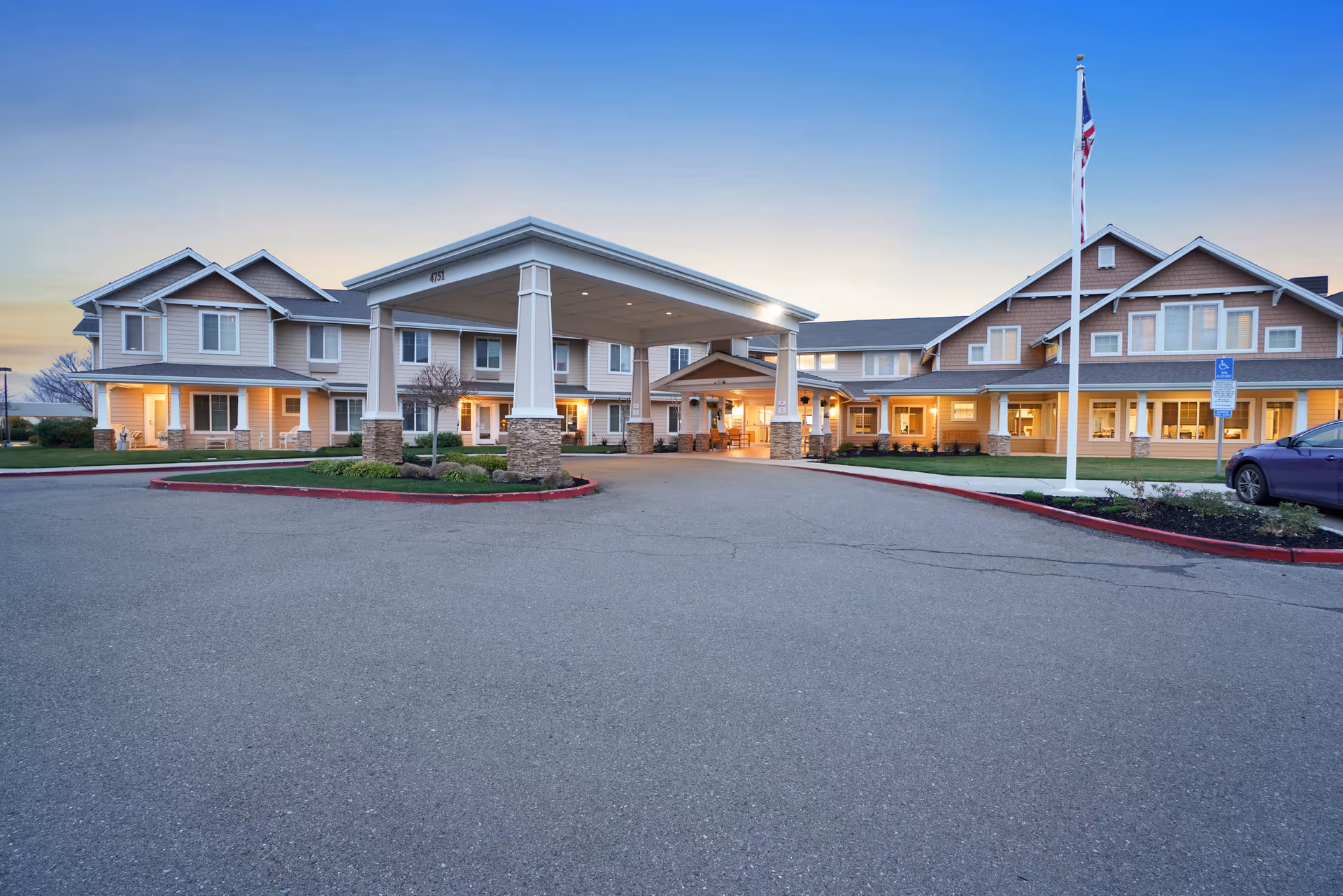 Exterior view of The Commons at Dallas Ranch with a covered entrance and parking.