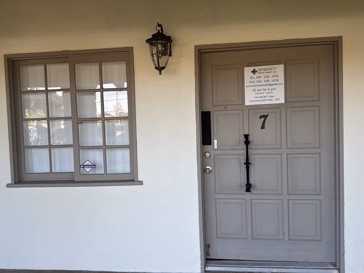 Exterior view of Seniority Home Health Inc. entrance with door and window.