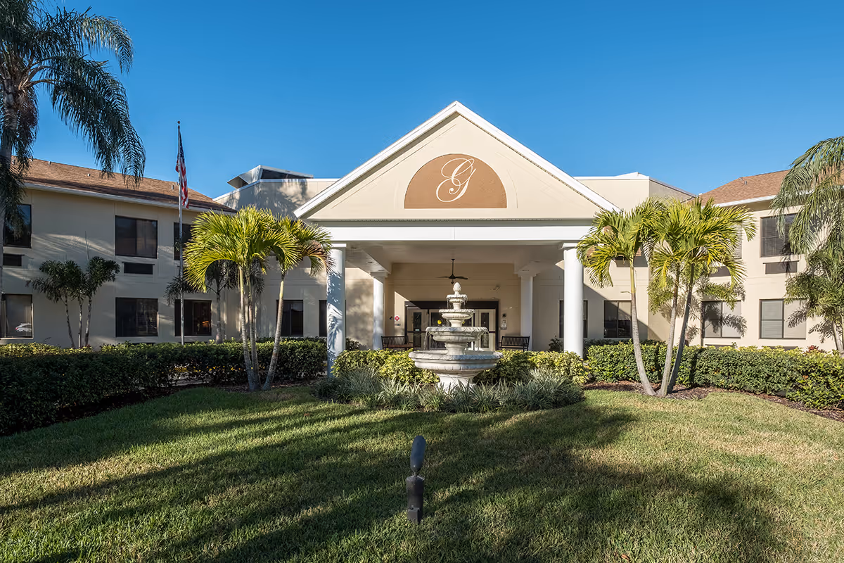 Front entrance of Volante of Dunedin with fountain, landscaping, and palm trees.