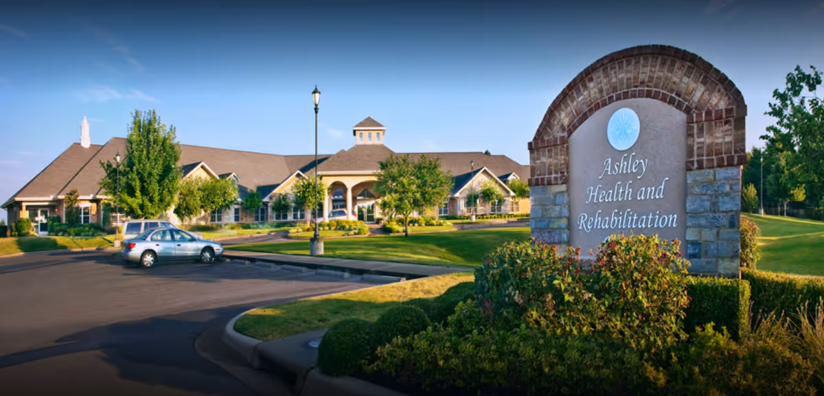 Exterior view of Ashley Health and Rehabilitation Center with sign and manicured landscaping.