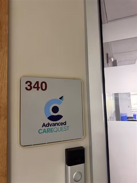 Door sign shows room 340 and Advanced CAREQUEST logo on interior wall.