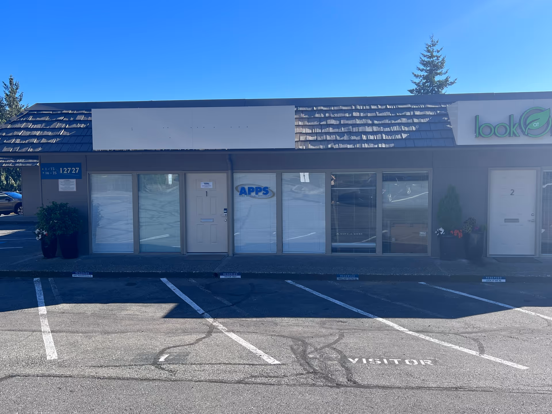 Exterior storefront of APPS Paramedical Services with parking spaces in front.
