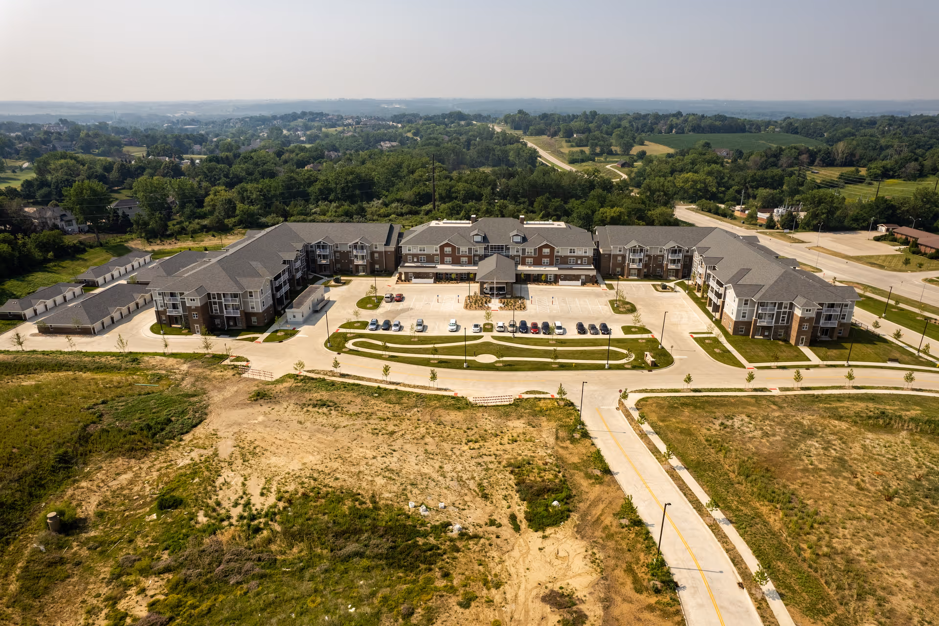 Aerial view of Glen Meadows senior living campus with circular driveway and parking.