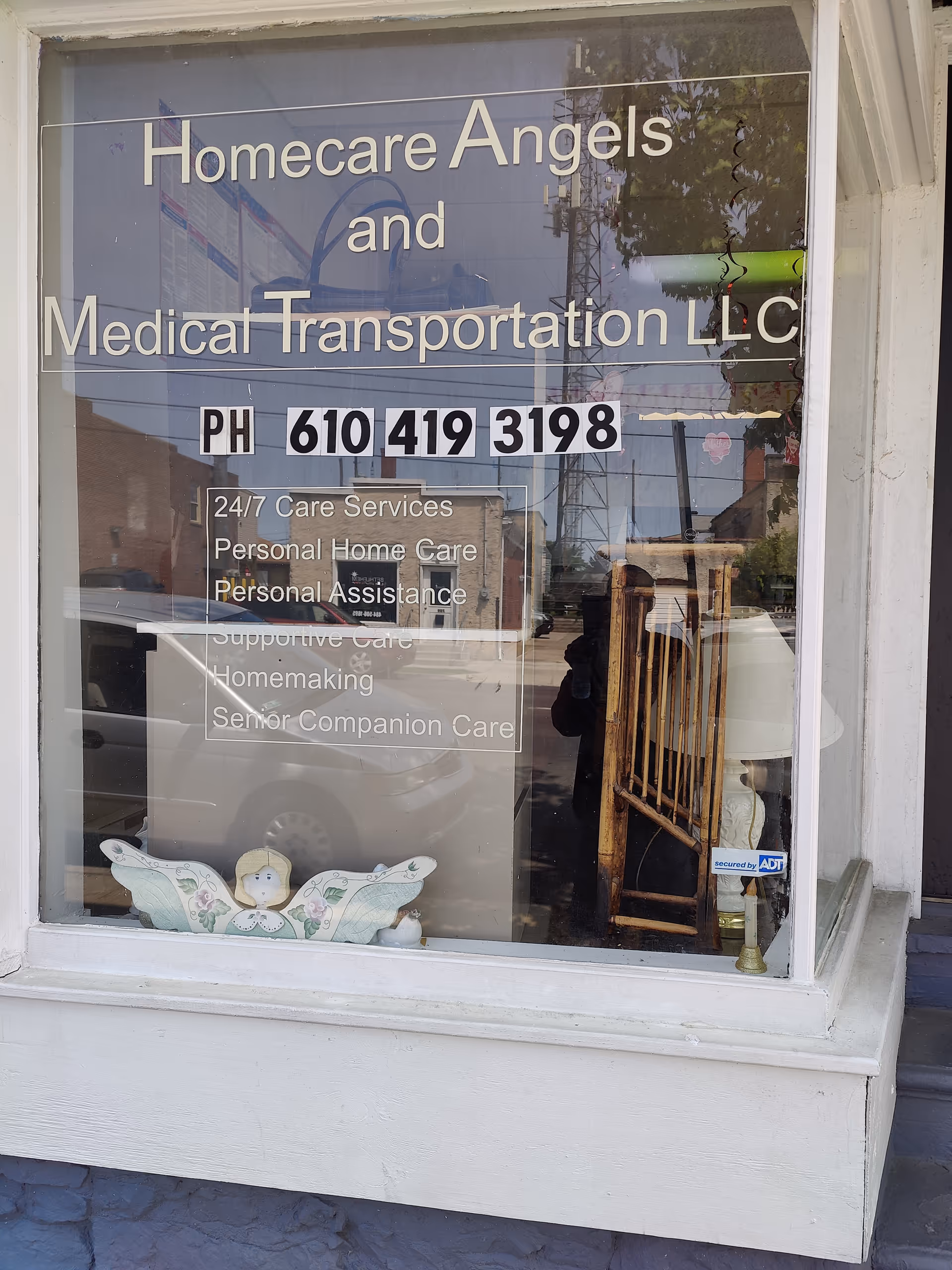 Front window sign for Homecare Angels and Medical Transportation LLC with contact number.