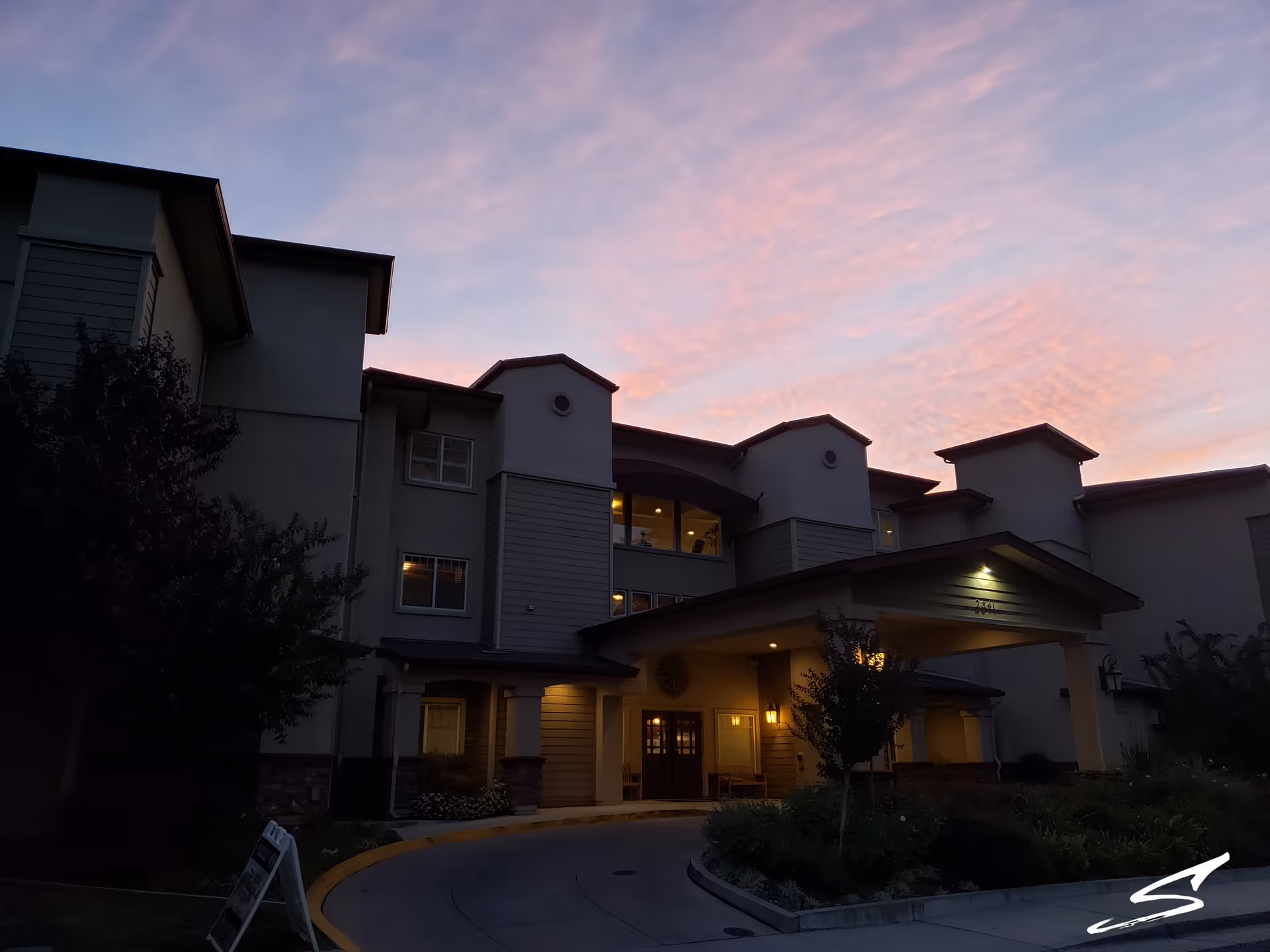 Exterior view of Summerset Senior Living facility at dusk with a covered entrance.