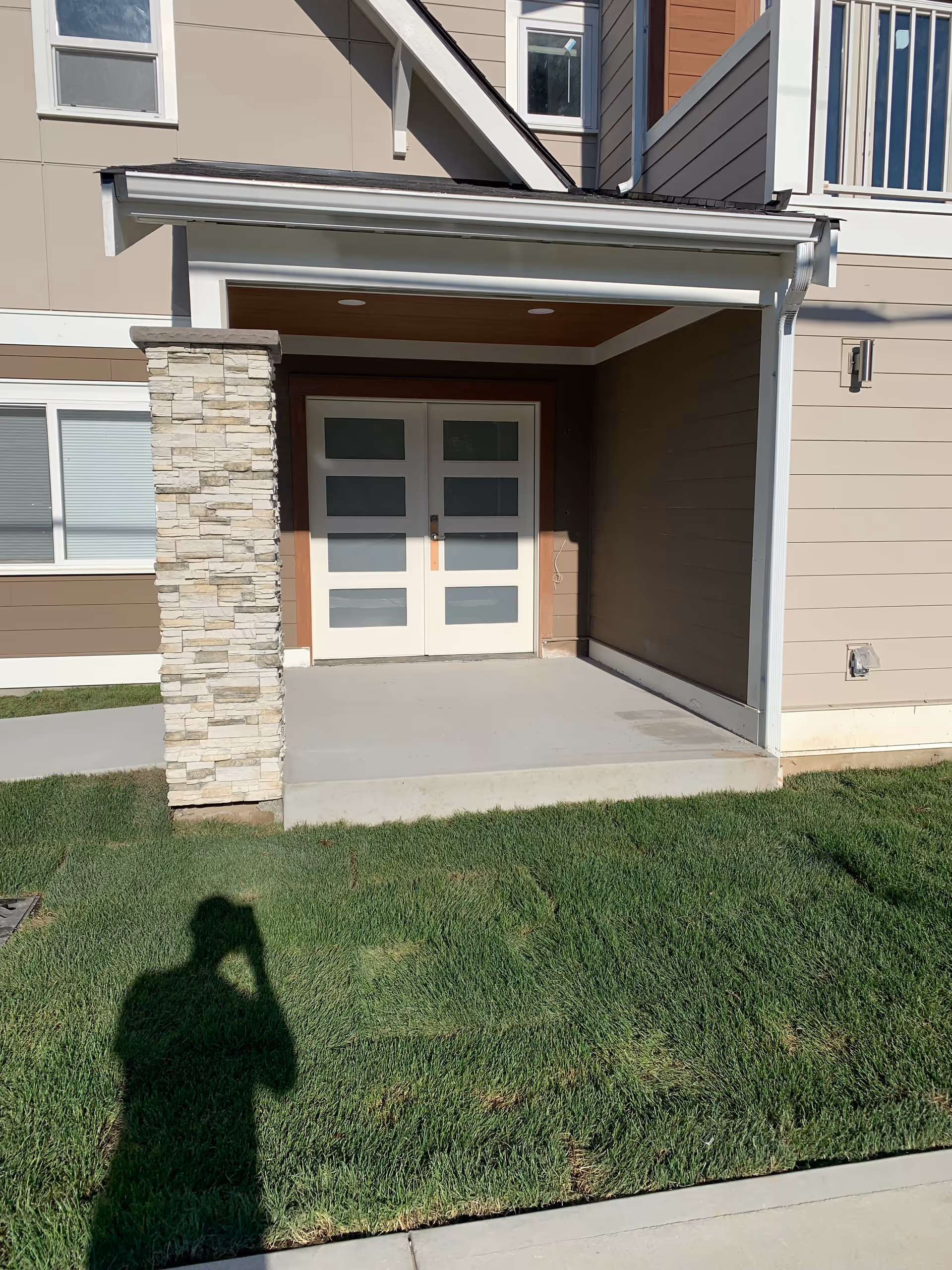 Front entrance of 1st Line Adult Family Home LLC, featuring double doors and stone pillar.