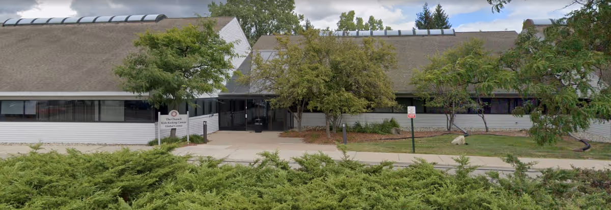 Exterior view of Panda Care Homecare facility with a walkway and front greenery.