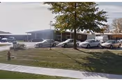 Exterior view of Solon Nursing Care Center with parked cars and trees in front