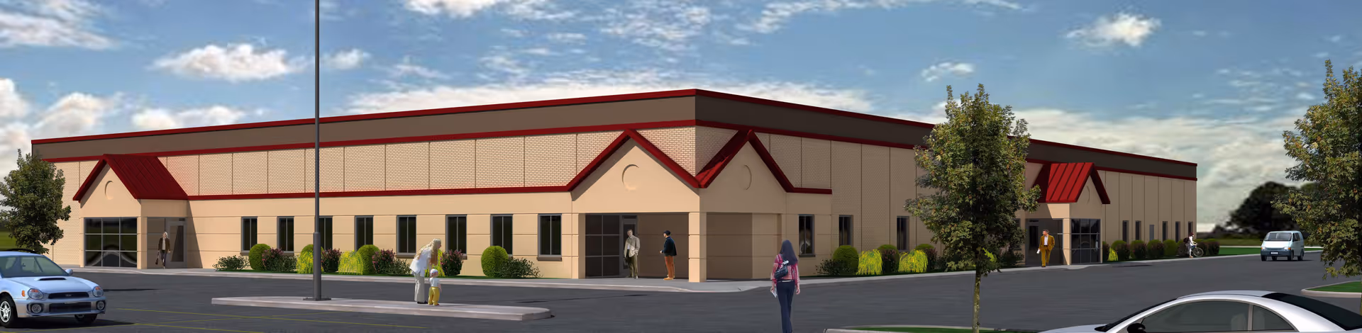 A single-story beige building with red trim, a parking lot, trees, and people by entrances.