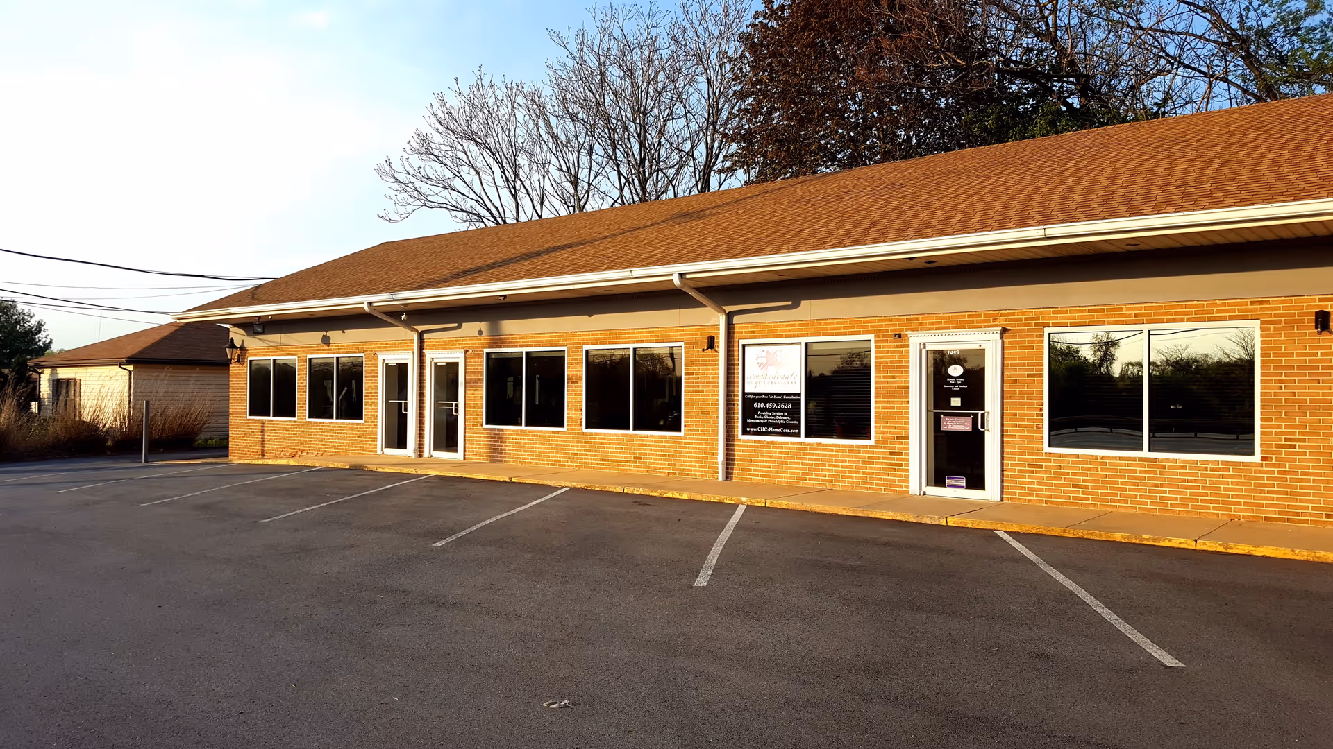 Front view of Compassionate Home Caregivers facility, a single-story brick building.