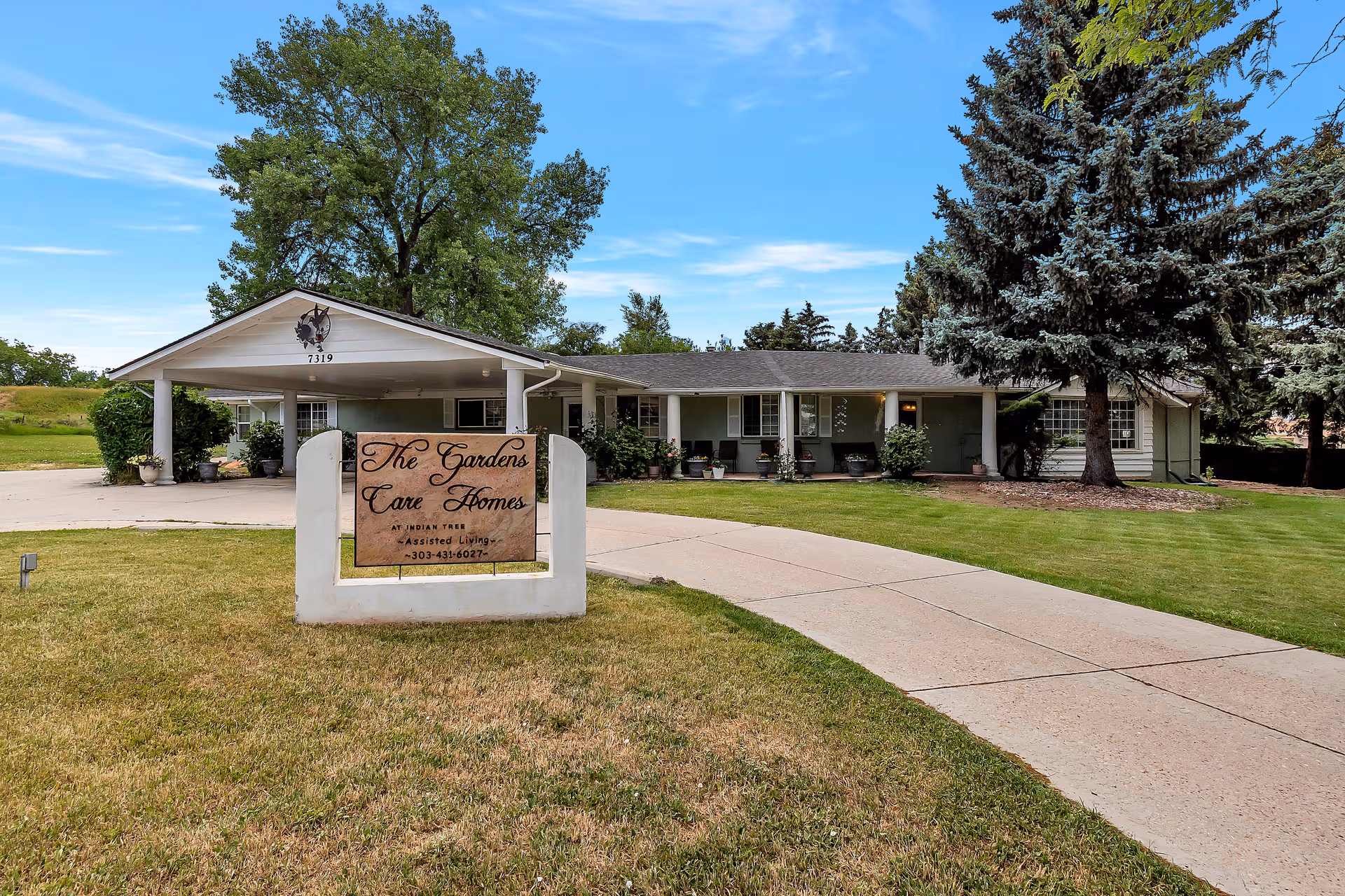 Front exterior of Gardens Care Homes Indian Tree, a single-story facility with a curved driveway.
