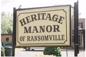 A Heritage Manor of Ransomville sign stands in front of the building.