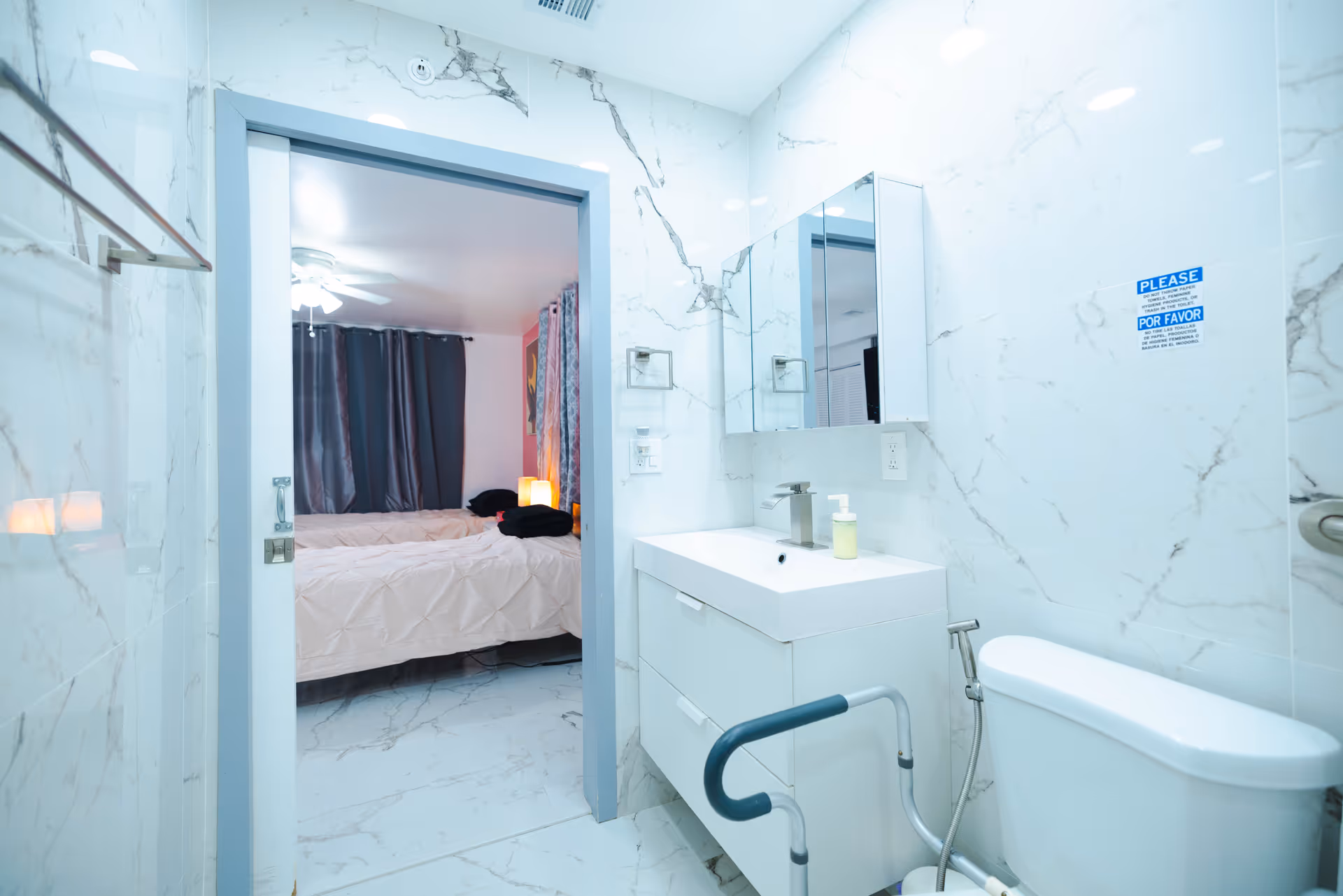 Interior view of a modern bathroom connected to a bedroom.