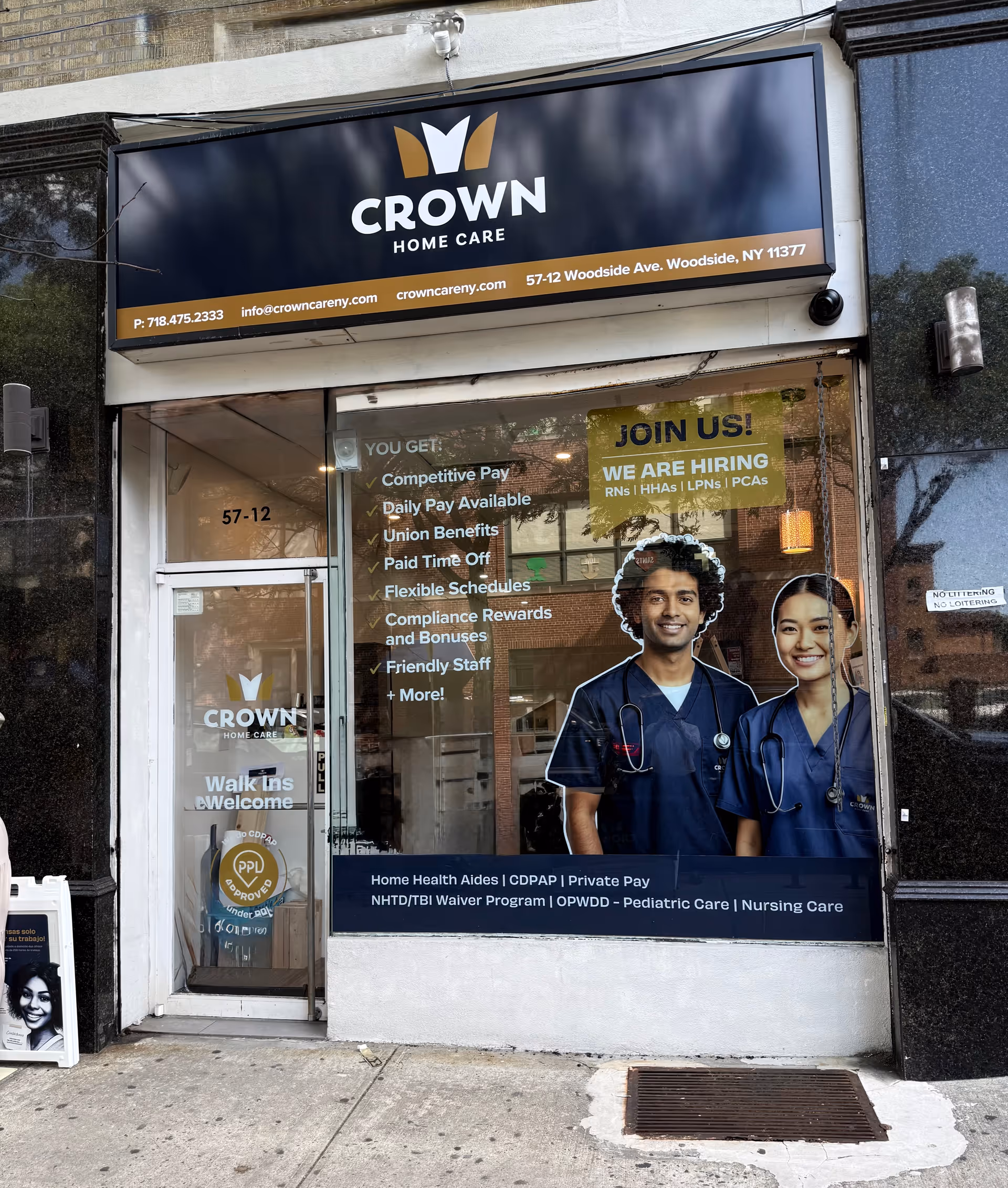 Storefront for Crown Home Care with a doorway and large window advertisement featuring two healthcare workers.