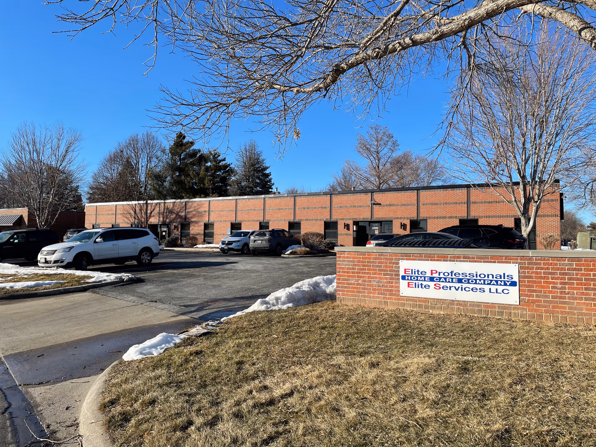 Exterior view of Elite Professionals Home Care building with cars in the parking lot.