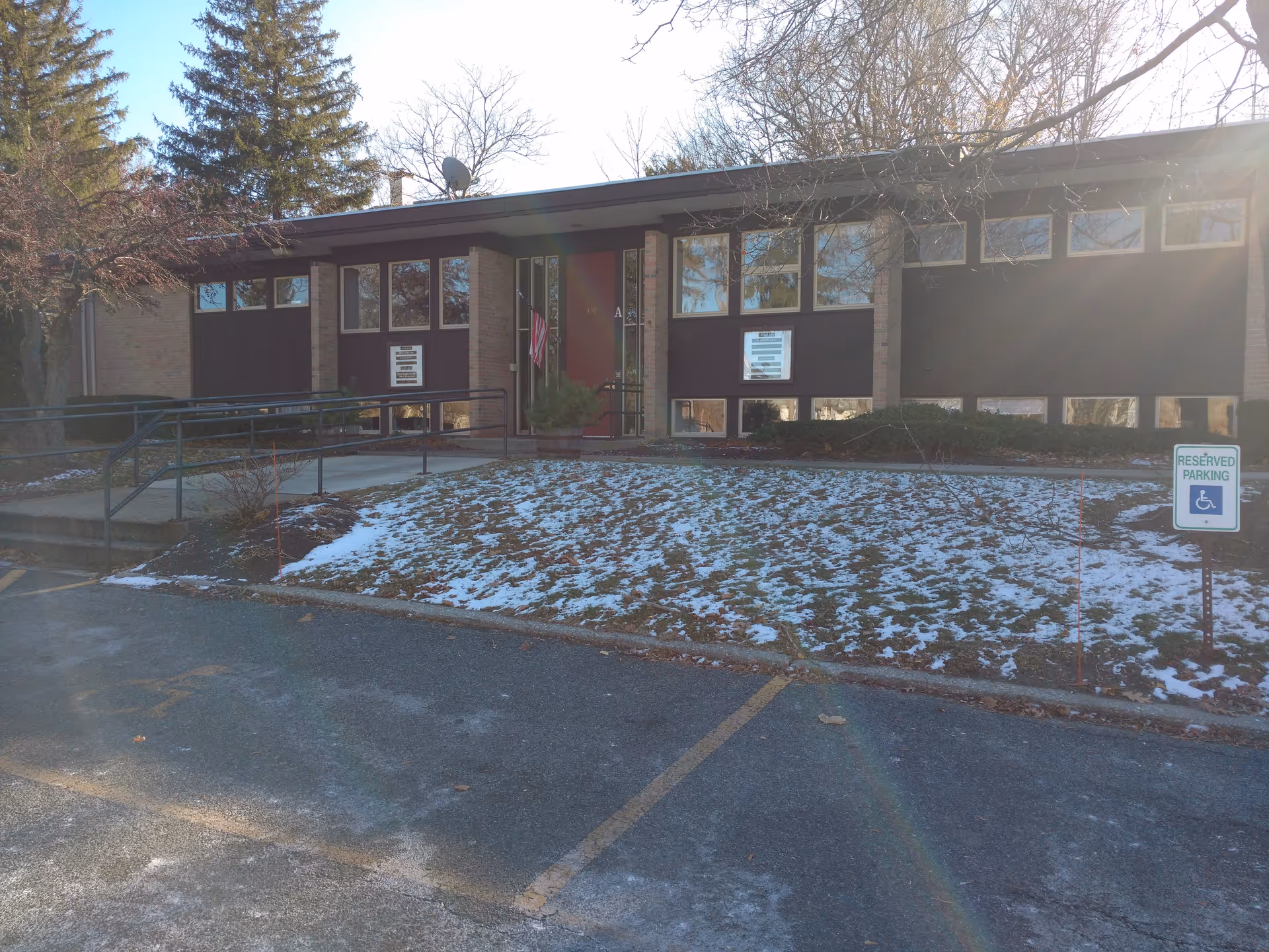Front exterior view of Visiting Angels Senior Home Care Pittsfield building with snow and parking.