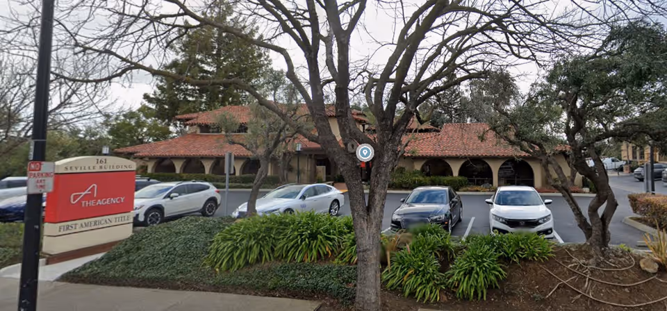 Exterior view of StarLight CareGivers, Inc. facility with red-tiled roof and parking.