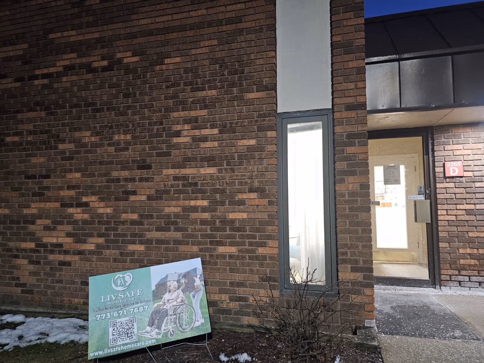 Brick exterior of a building with a front entrance and LivSafe Home Care sign