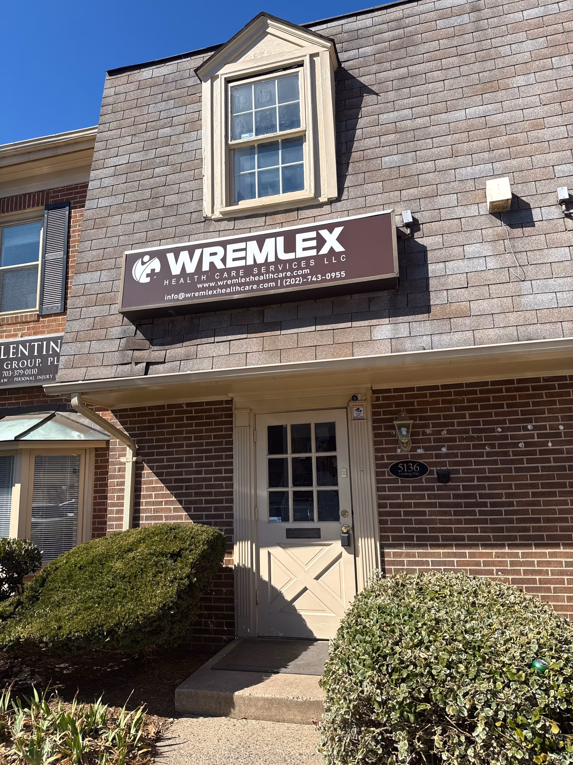 Exterior view of a brick building with a Wremlex Health Care Services sign and entrance.