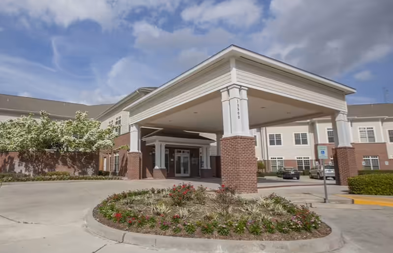 Exterior view of Niles Nursing & Rehabilitation entrance with a covered drop-off and landscaping.