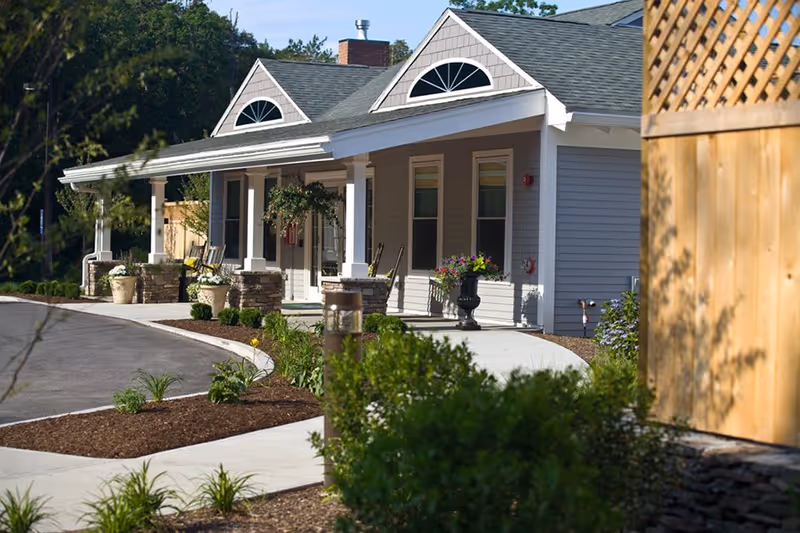 Front view of Avita of Needham, a single-story senior living facility with a covered entrance.