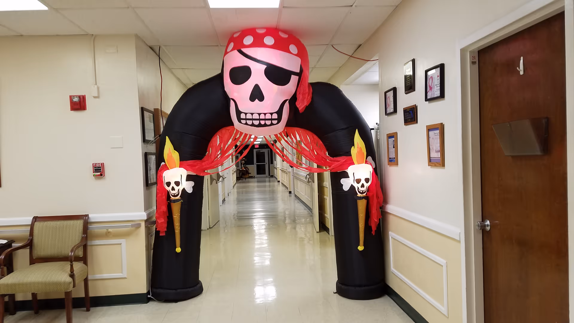 Indoor hallway with a large inflatable pirate arch decoration at the center.