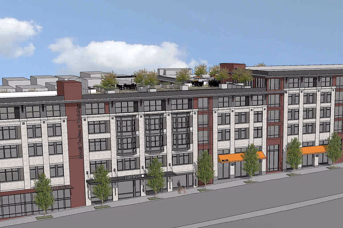 Exterior view of Merrill Gardens at Rockridge, a multi-story building with storefronts and rooftop terrace.