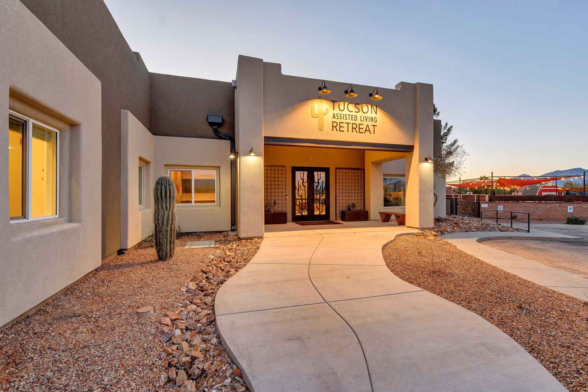 Exterior view of Tucson Assisted Living Retreat entrance with a curved walkway.