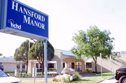Hansford Manor sign and the facility entrance with trees and landscaping.