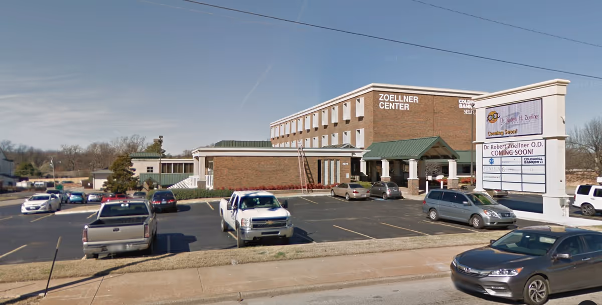 Brick building labeled Zoellner Center with surrounding parking lot.