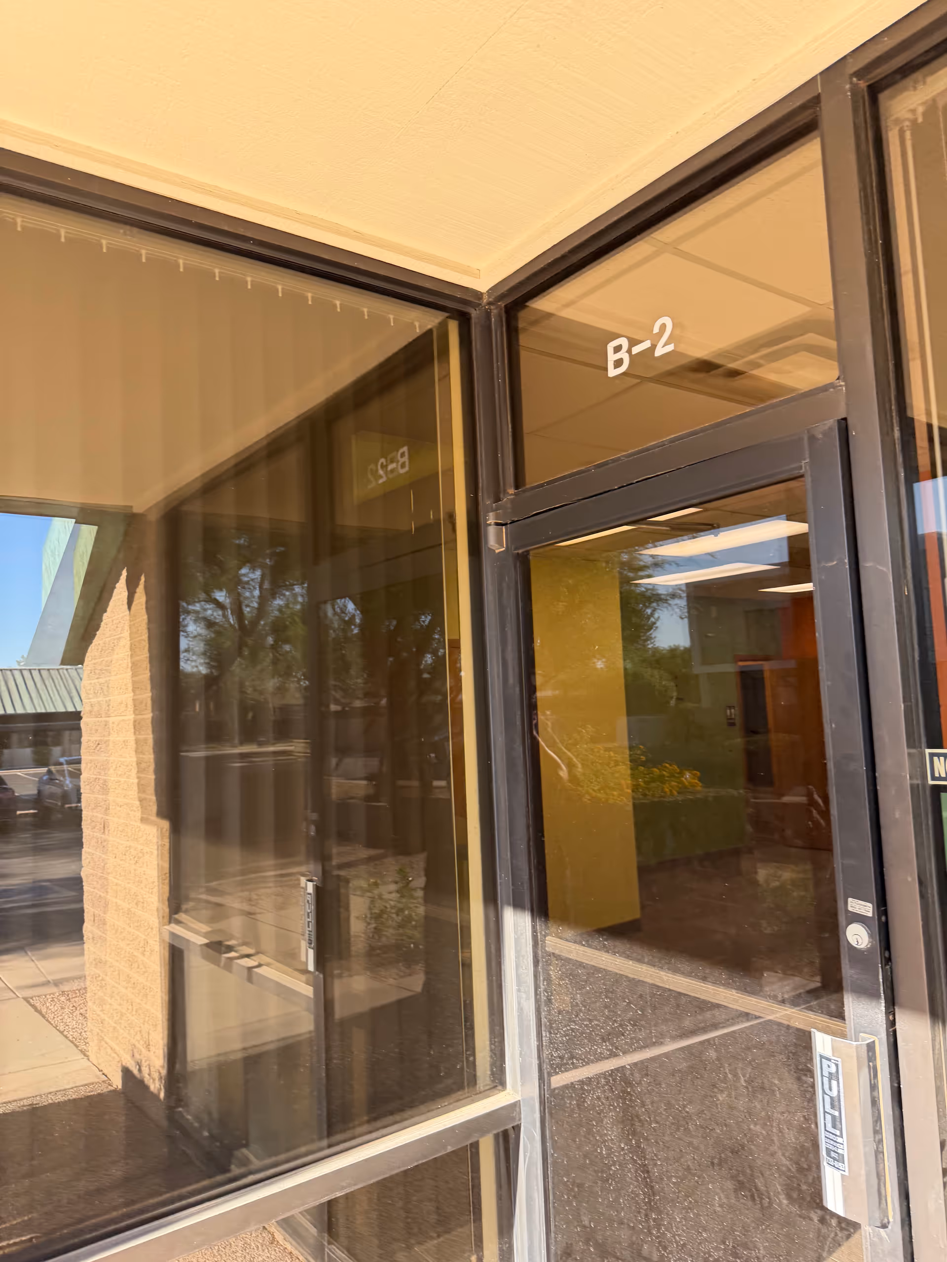 Glass entrance doors with a B-2 marking at the facility's front.