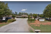 Paved entrance road leads to a low, single-story building with a Foothills sign.