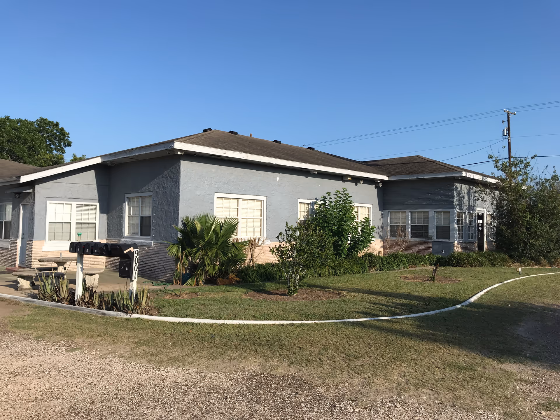 Exterior view of a single-story Medic Home Care Inc building with lawn and sign.