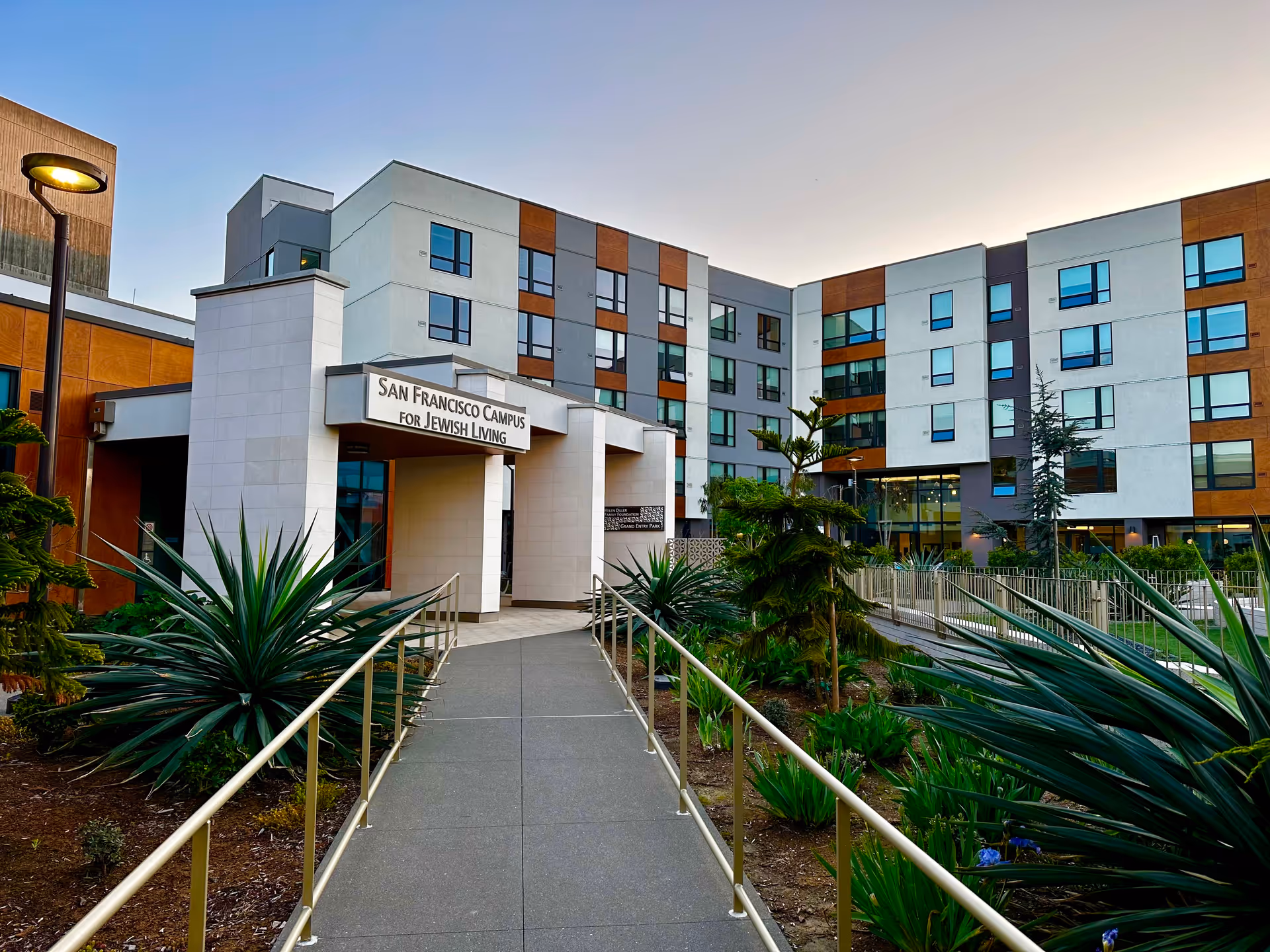 Exterior view of San Francisco Campus for Jewish Living with entrance and landscaped walkway.