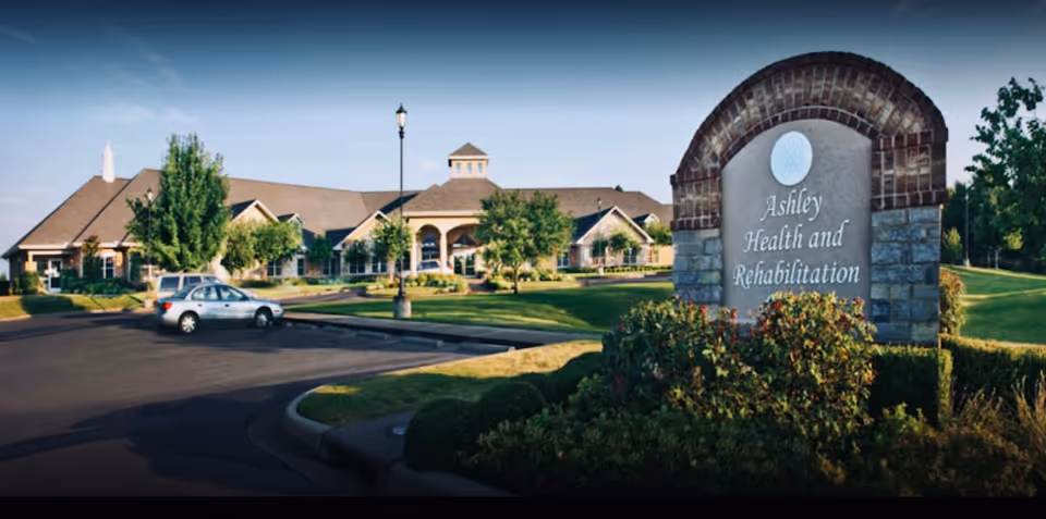 Exterior view of Ashley Rehabilitation and Health Care Center with sign and driveway.