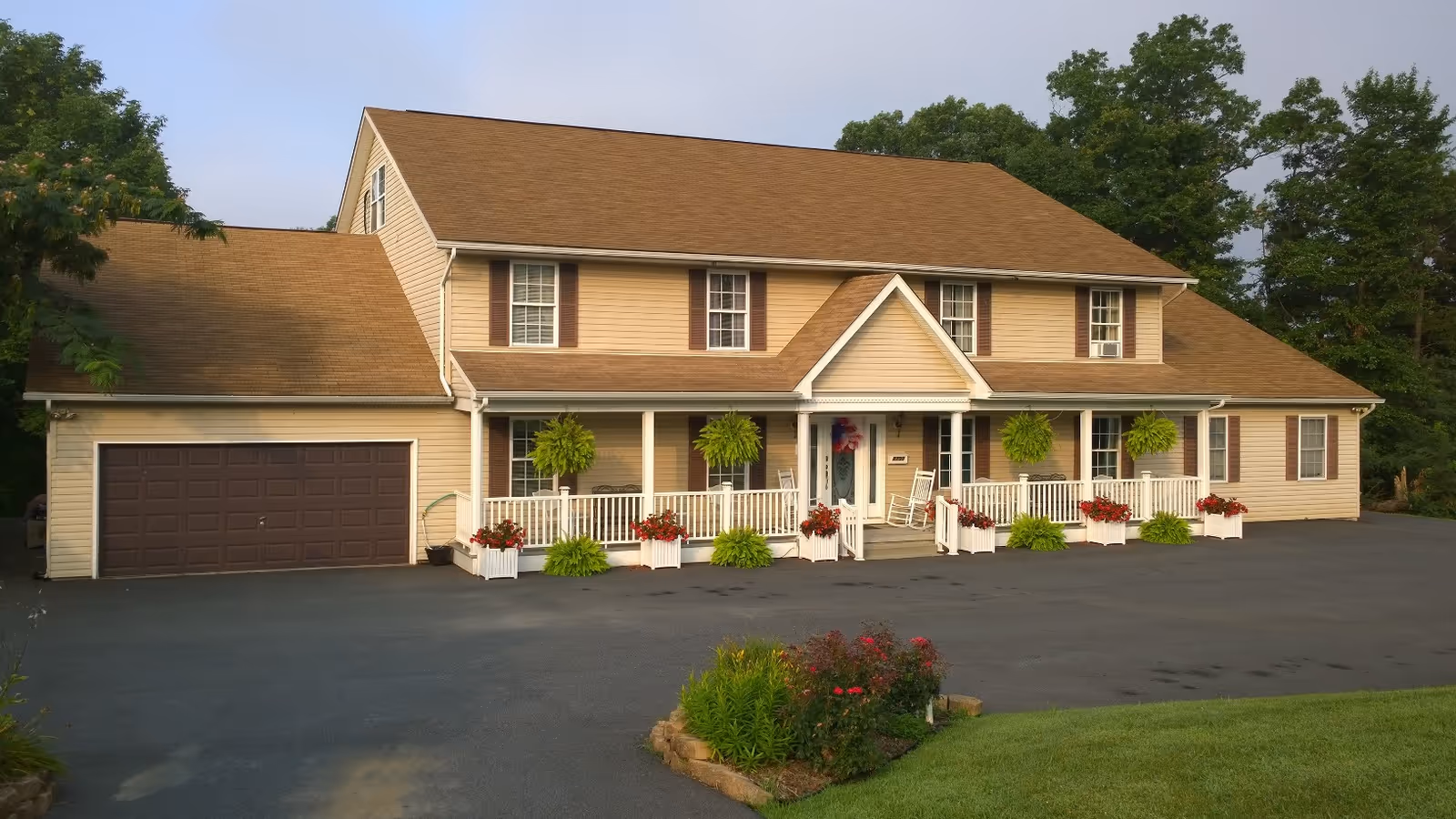 Exterior view of Cheryl's Place, a tan two-story senior living facility with a front porch.