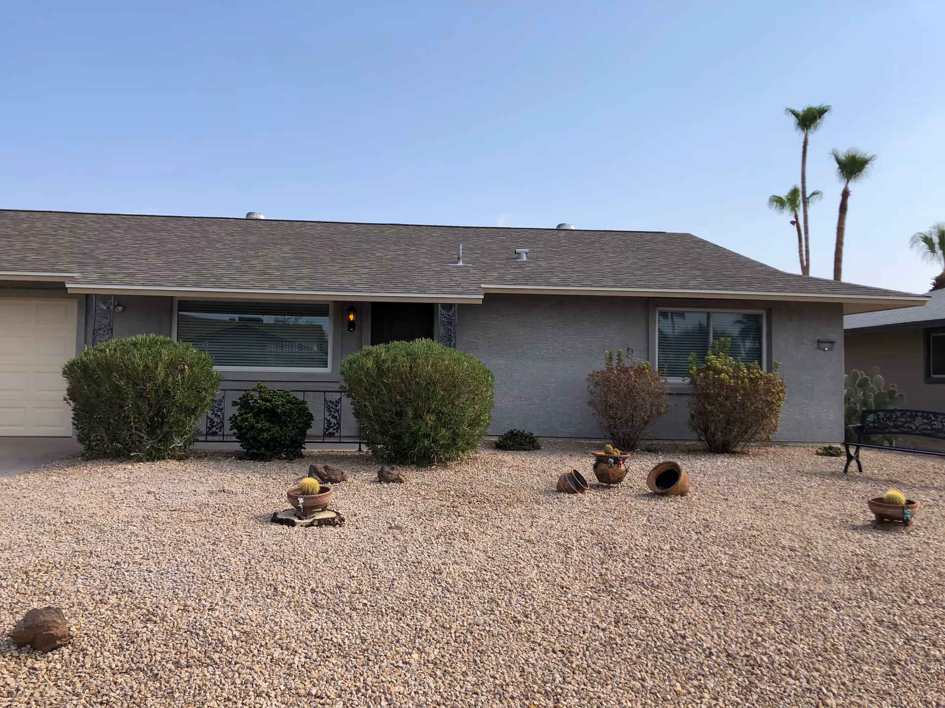 Front exterior of Desert Terrace Healthcare Center with gravel yard and desert plants.