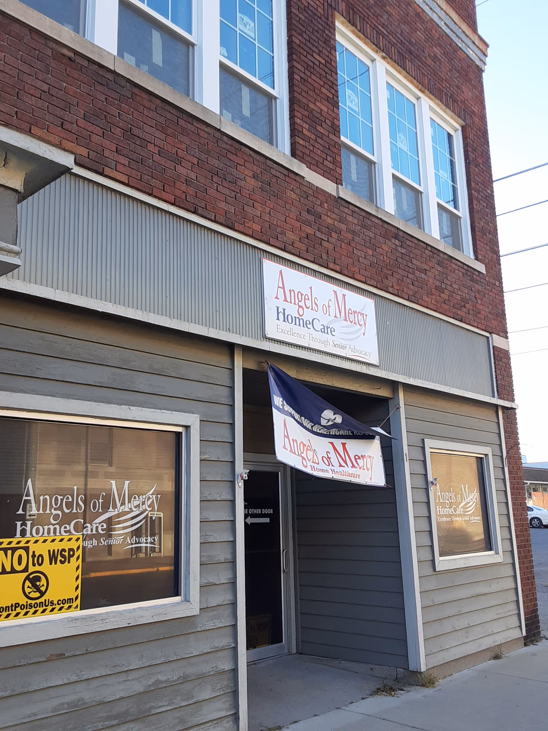 Exterior view of a brick building with Angels of Mercy HomeCare signage.