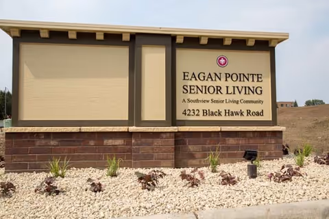 Exterior sign for Eagan Pointe Senior Living on a landscaped front lawn.