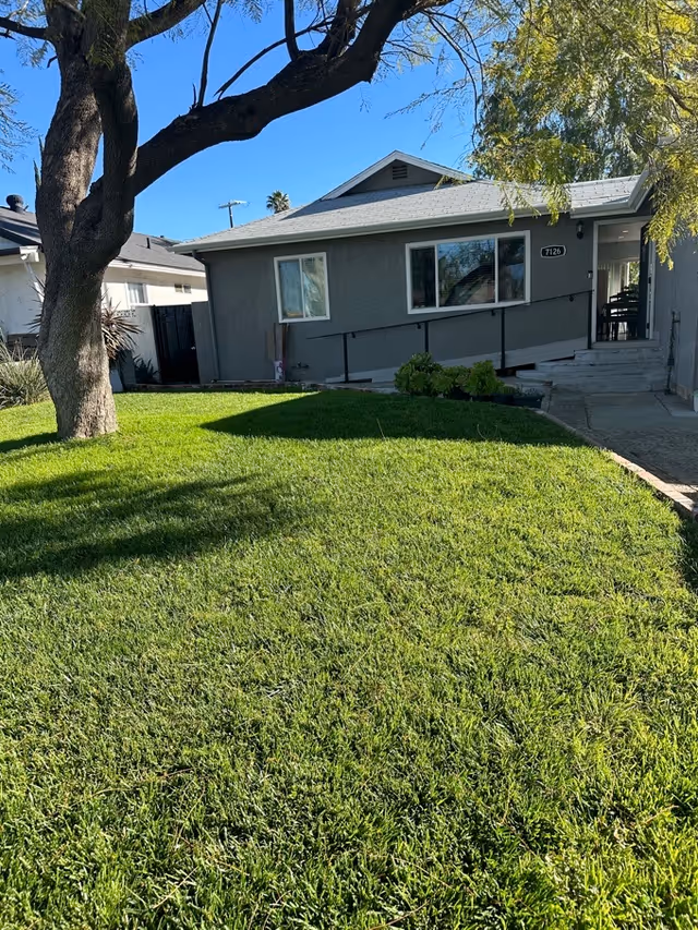 Exterior view of Elder Joy Oasis building with front lawn and ramp.