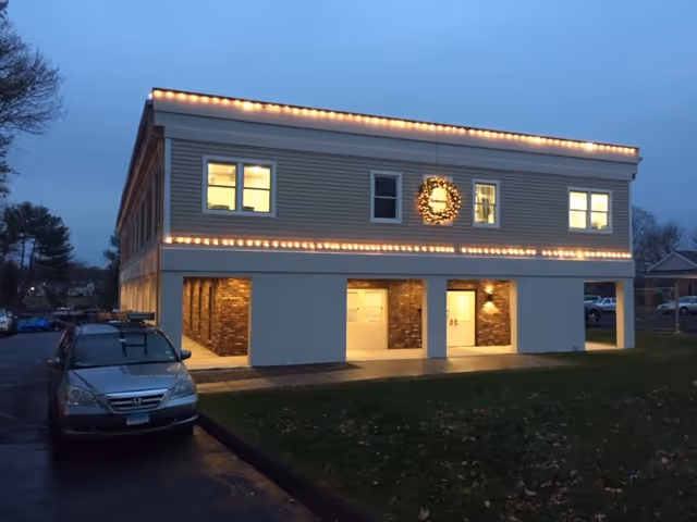 Front exterior of Stratford Visiting Nurse Association building, decorated with lights and a wreath.