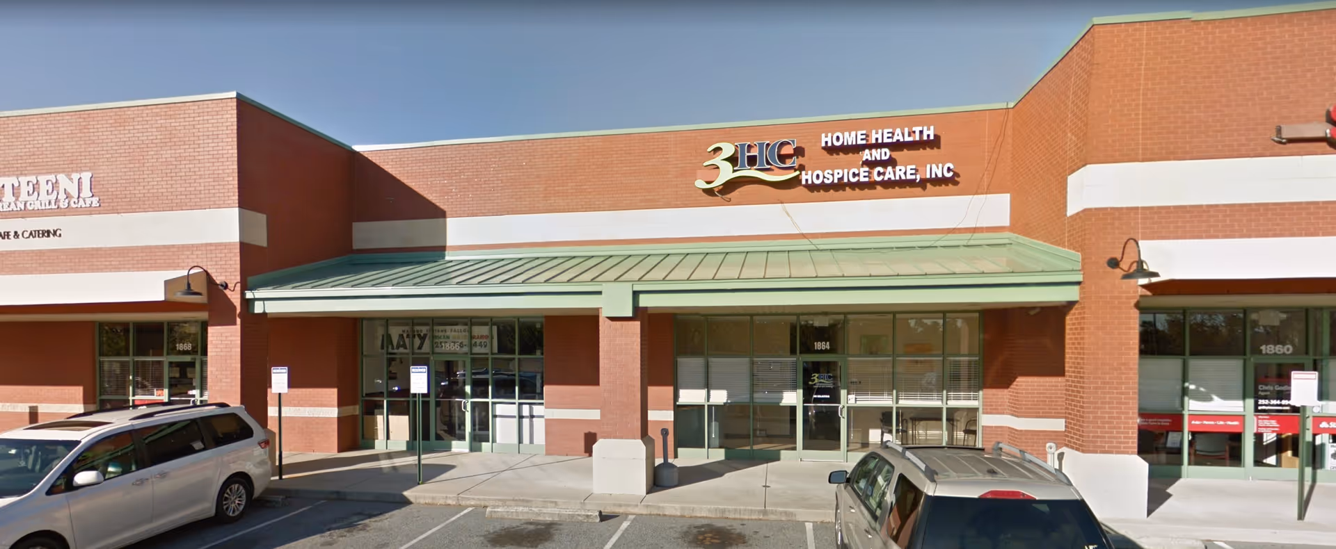 Exterior brick storefront for 3HC Home Health and Hospice Care with parked cars.