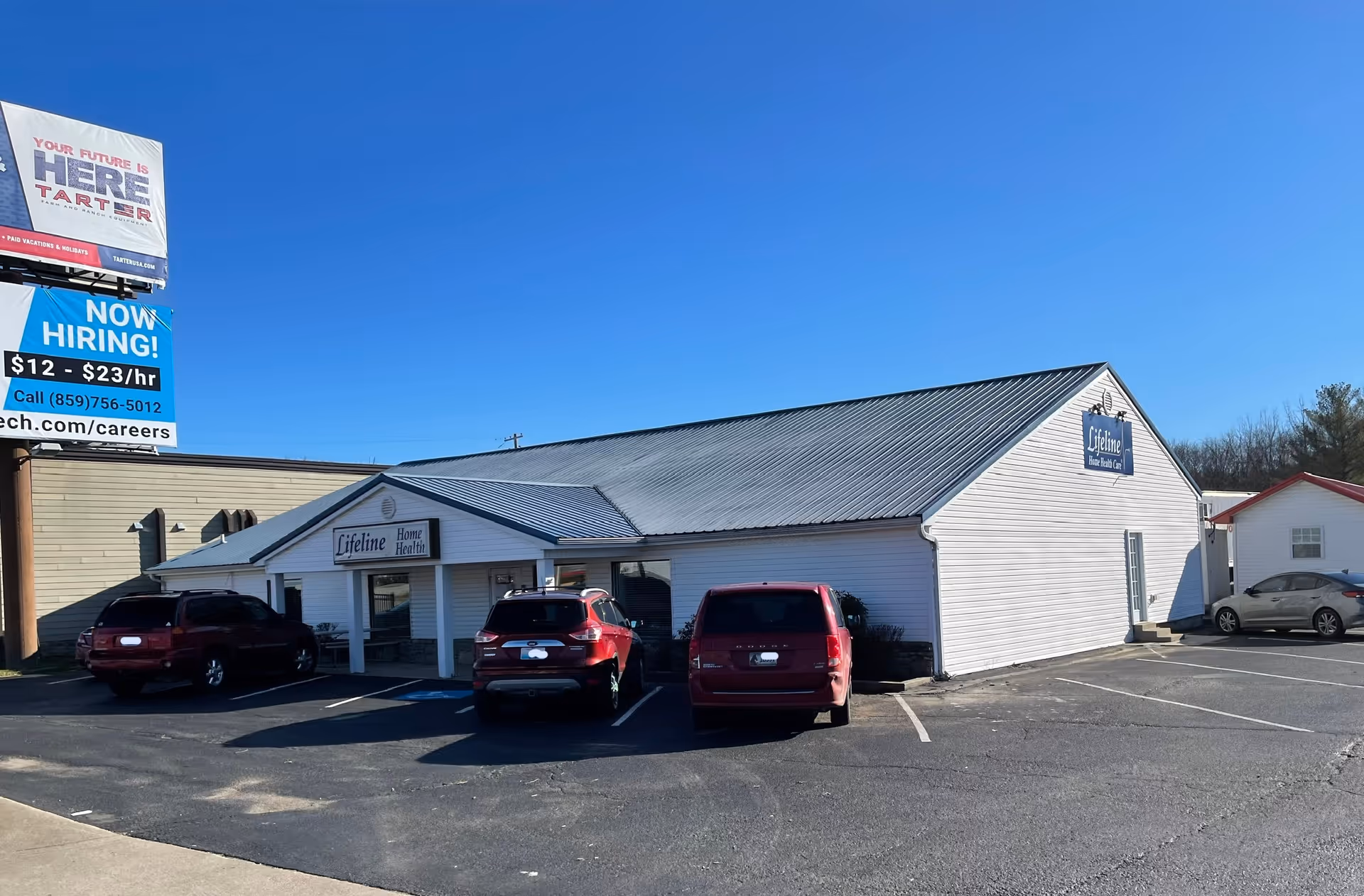 Exterior view of Lifeline Home Health building with parked cars in front.