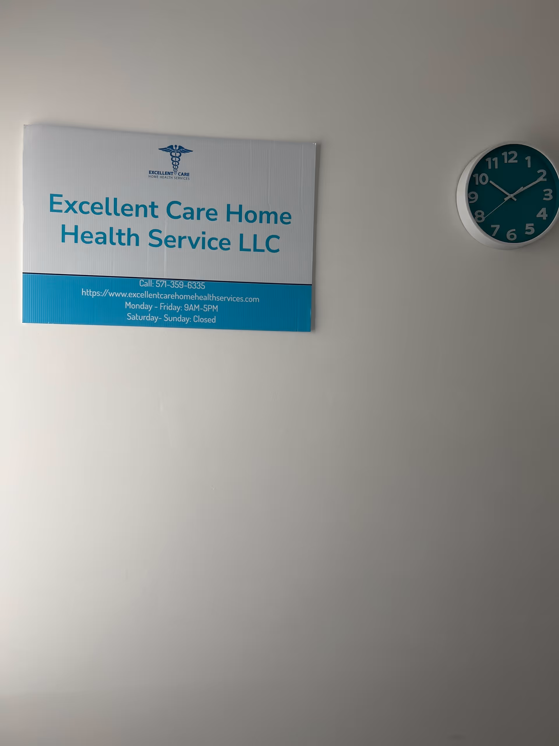 Interior wall with a sign reading Excellent Care Home Health Service LLC and a teal clock