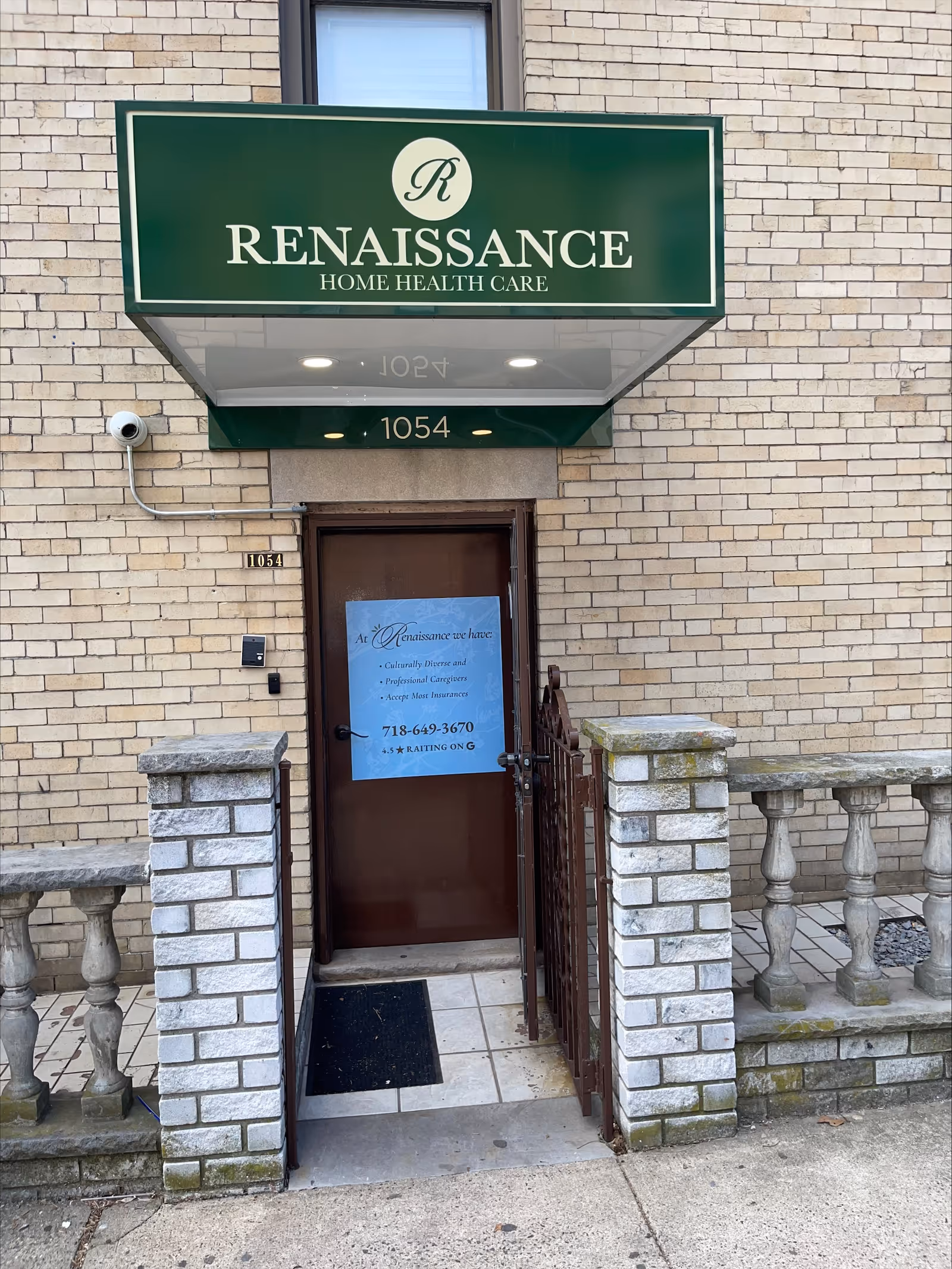 Green sign reading Renaissance Home Health Care above a brown door on a brick building entrance.